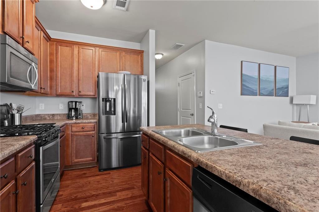 63 Creighton Lane Marietta, GA 30008 - Photo 11 of 23 a kitchen with granite countertop a sink stove and refrigerator