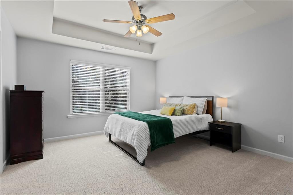 63 Creighton Lane Marietta, GA 30008 - Photo 13 of 23 a spacious bedroom with a bed and a chandelier