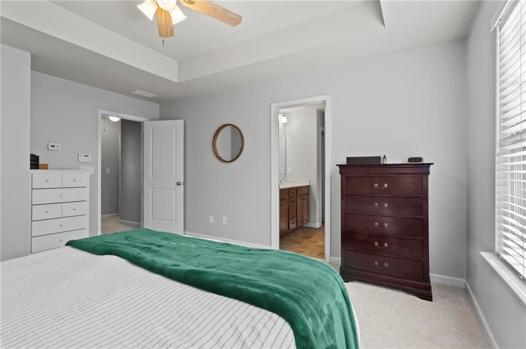 63 Creighton Lane Marietta, GA 30008 - Photo 14 of 23 a bedroom with a dresser and a chandelier