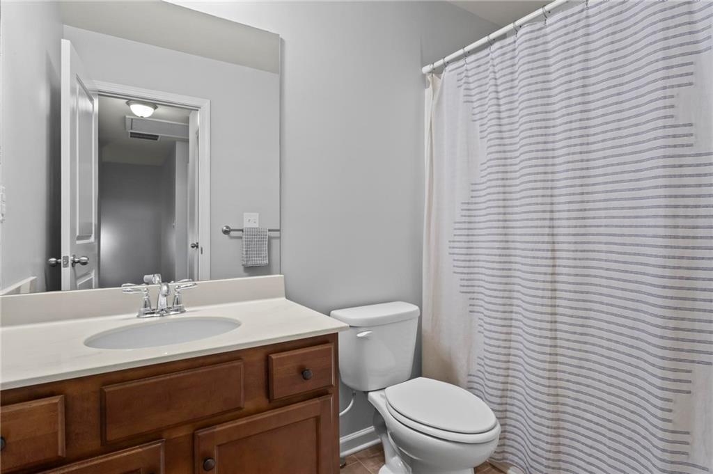 63 Creighton Lane Marietta, GA 30008 - Photo 19 of 23 a bathroom with a sink a toilet and mirror