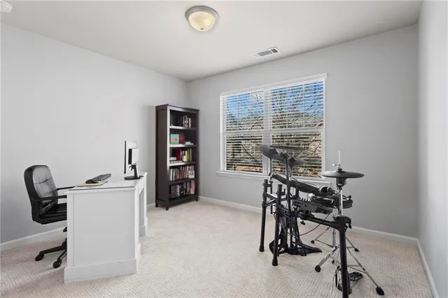 a view of a workspace with furniture and a window