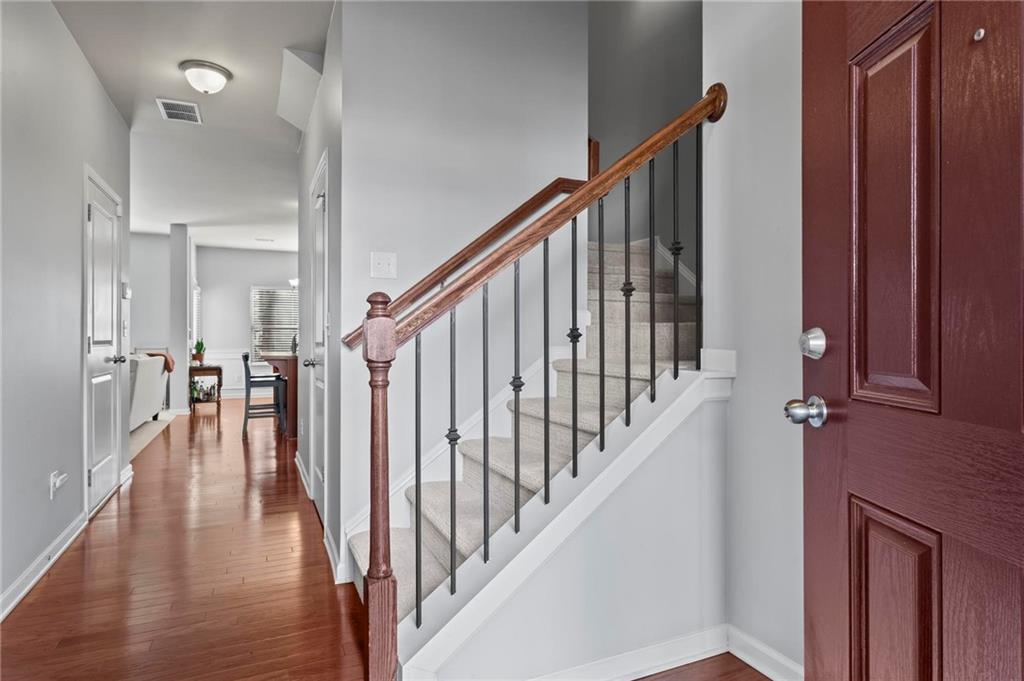 63 Creighton Lane Marietta, GA 30008 - Photo 2 of 23 a view of staircase with lots of frames on wall and wooden floor