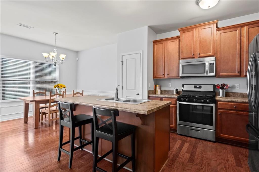 63 Creighton Lane Marietta, GA 30008 - Photo 7 of 23 a kitchen with a stove a sink and chairs