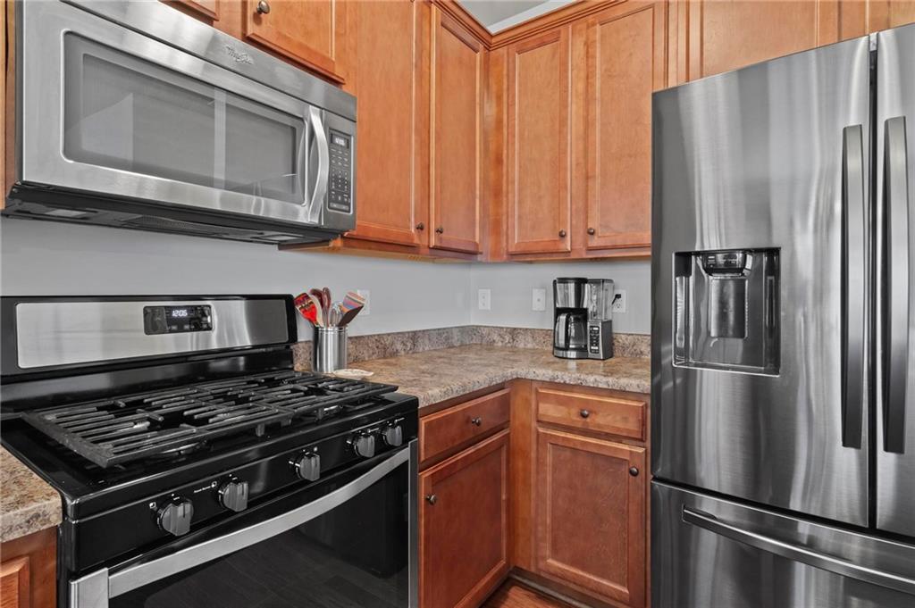 63 Creighton Lane Marietta, GA 30008 - Photo 9 of 23 a kitchen with stainless steel appliances granite countertop a refrigerator stove top oven and sink