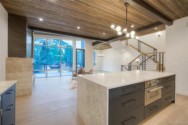 a kitchen with a sink dishwasher a stove and a refrigerator with wooden floor