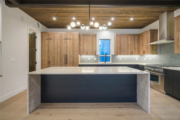 a kitchen with stainless steel appliances granite countertop a sink a stove and a microwave
