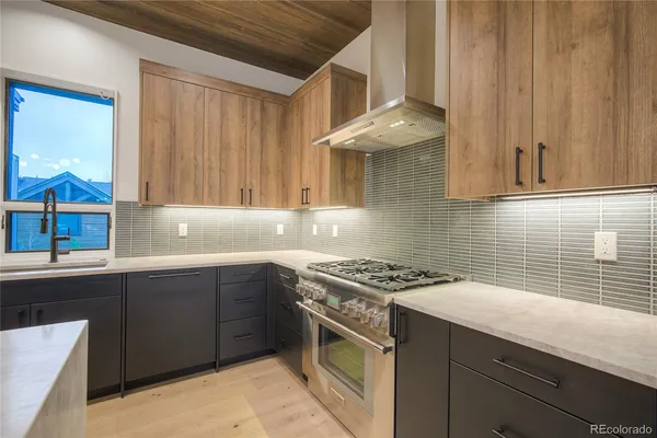 a kitchen with a sink stove and cabinets