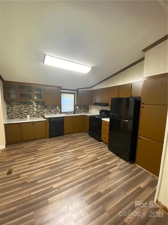 675 Hendricks Road Salisbury, NC 28147 - Photo 4 of 17 a kitchen with stainless steel appliances kitchen island sink refrigerator and stove