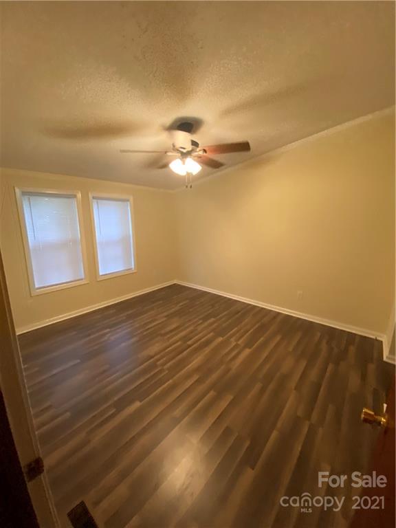 675 Hendricks Road Salisbury, NC 28147 - Photo 6 of 17 a view of a room with wooden floor and a ceiling fan