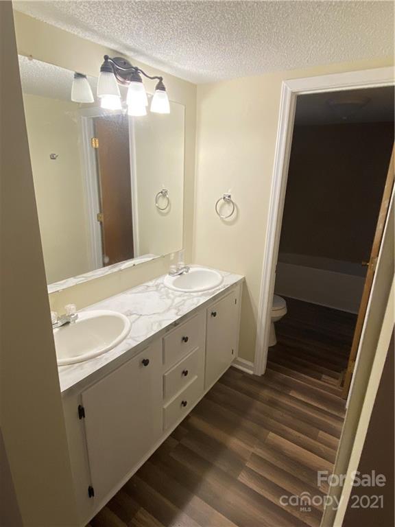 675 Hendricks Road Salisbury, NC 28147 - Photo 8 of 17 a bathroom with a double vanity sink and mirror