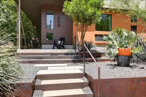 a view of a house with backyard and sitting area