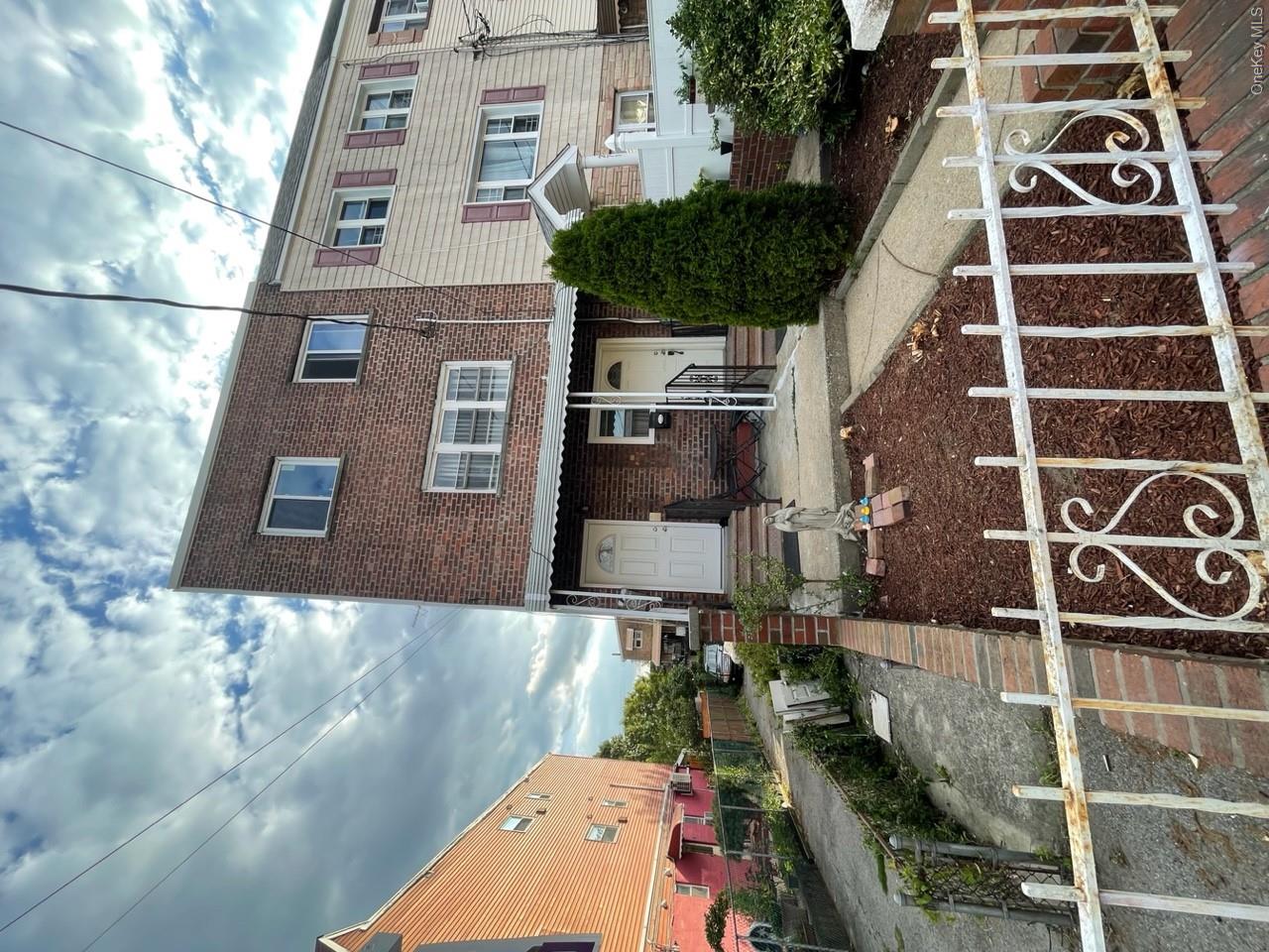 269 Balcom Avenue Bronx, NY 10465 - Photo 1 of 20 View of front of property with brick siding and a fenced front yard