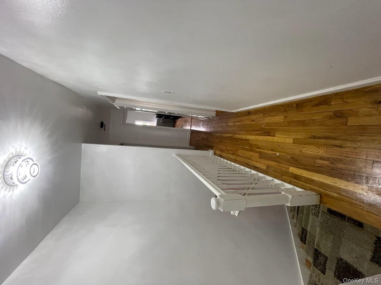269 Balcom Avenue Bronx, NY 10465 - Photo 12 of 20 Corridor featuring hardwood / wood-style floors and an upstairs landing