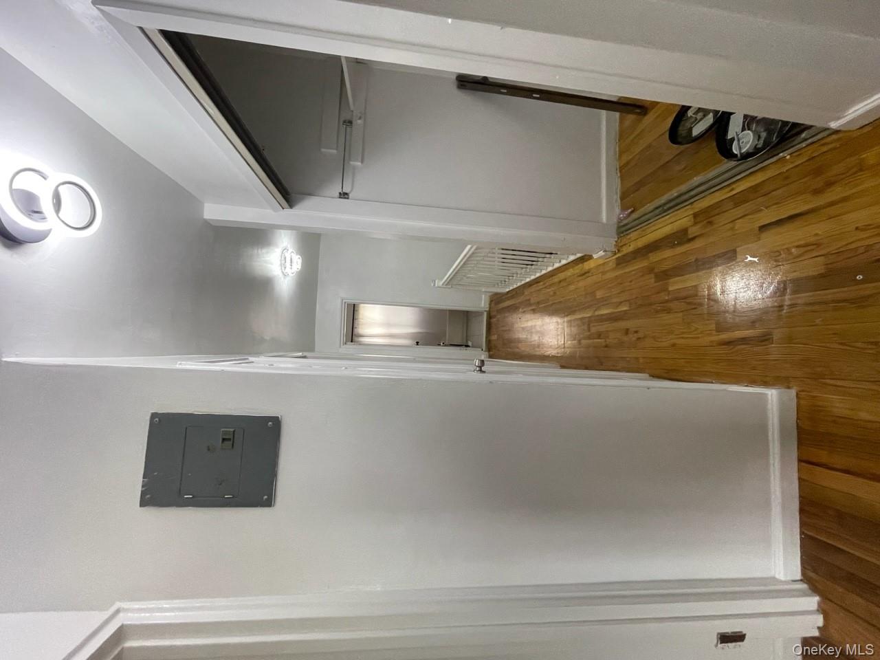 269 Balcom Avenue Bronx, NY 10465 - Photo 16 of 20 Corridor featuring wood finished floors and electric panel