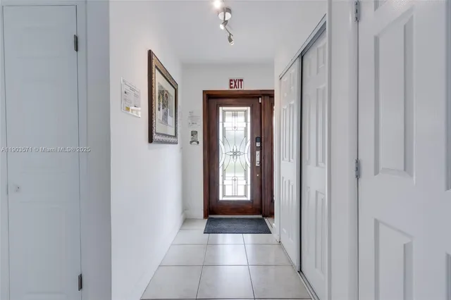 a view of a hallway with windows and closet
