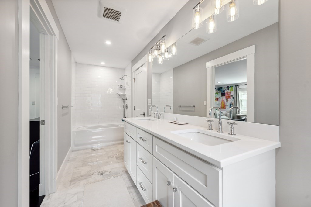 40 Carver Road Wellesley, MA 02481 - Photo 19 of 34 a spacious bathroom with a double vanity sink mirror and a bathtub