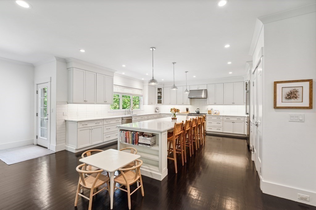 40 Carver Road Wellesley, MA 02481 - Photo 3 of 34 a kitchen with a table chairs wooden floors and a view of living room