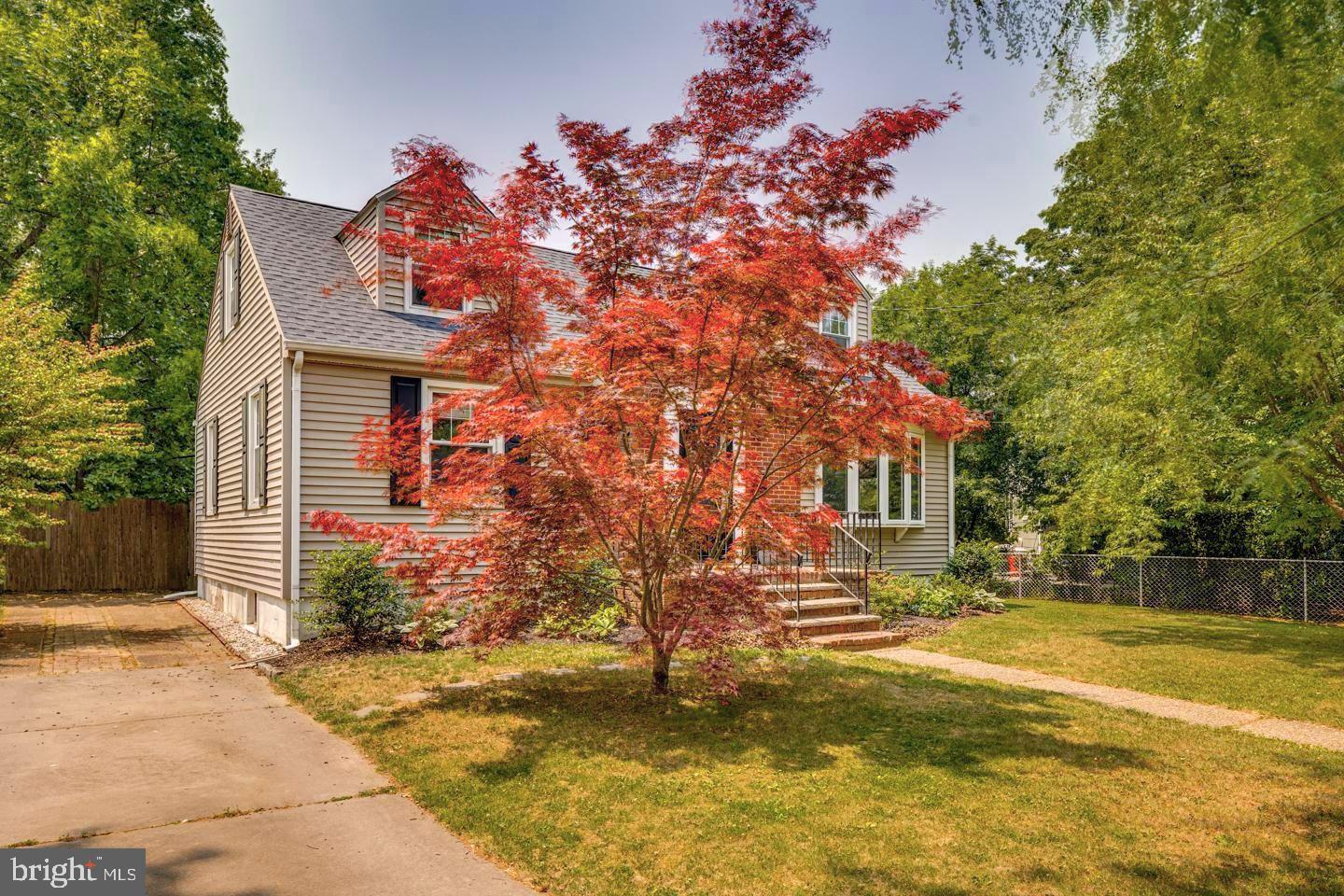 284 Bewley Road Haddonfield, NJ 08033 - Photo 3 of 36 a front view of a house with a yard tree and outdoor seating