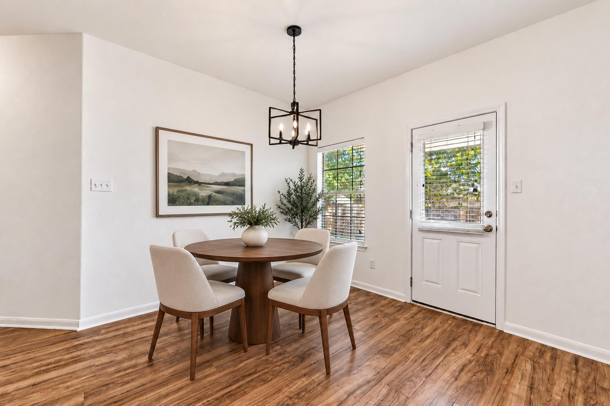 150 Engineers Pass Jarrell, TX 76537 - Photo 18 of 40 Rich wood-look flooring and abundant natural light define this inviting dining area.
