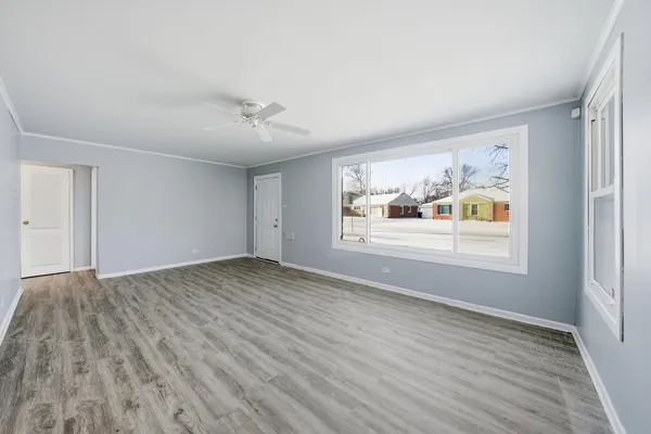 wooden floor in an empty room with a window
