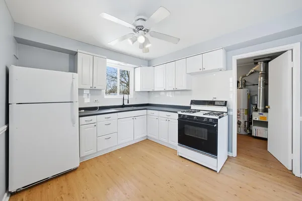 a kitchen with stainless steel appliances granite countertop a refrigerator and a stove top oven