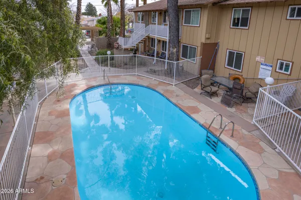 a view of a swimming pool with sitting area