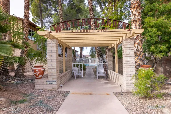 a view of a patio with table and chairs and a barbeque