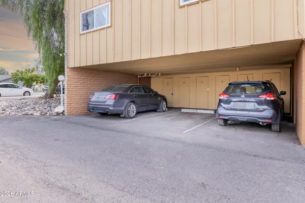 a couple of cars parked in parking area of a house