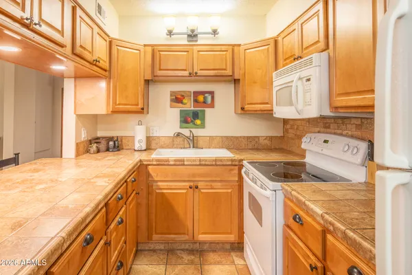 a kitchen with a sink stove and cabinets