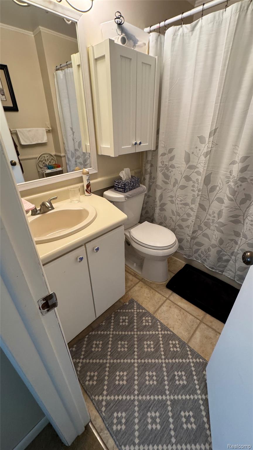 3828 Morgan Road Lake Orion, MI 48359 - Photo 33 of 39 Integrated vanity with counter space, wall-mounted storage cabinet, and tiled flooring