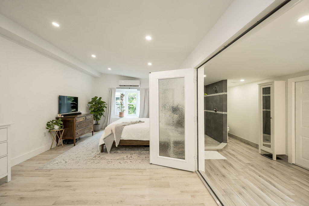 3402 Eagle Avenue Key West, FL 33040 - Photo 15 of 27 a living room with furniture a flat screen tv and a fireplace