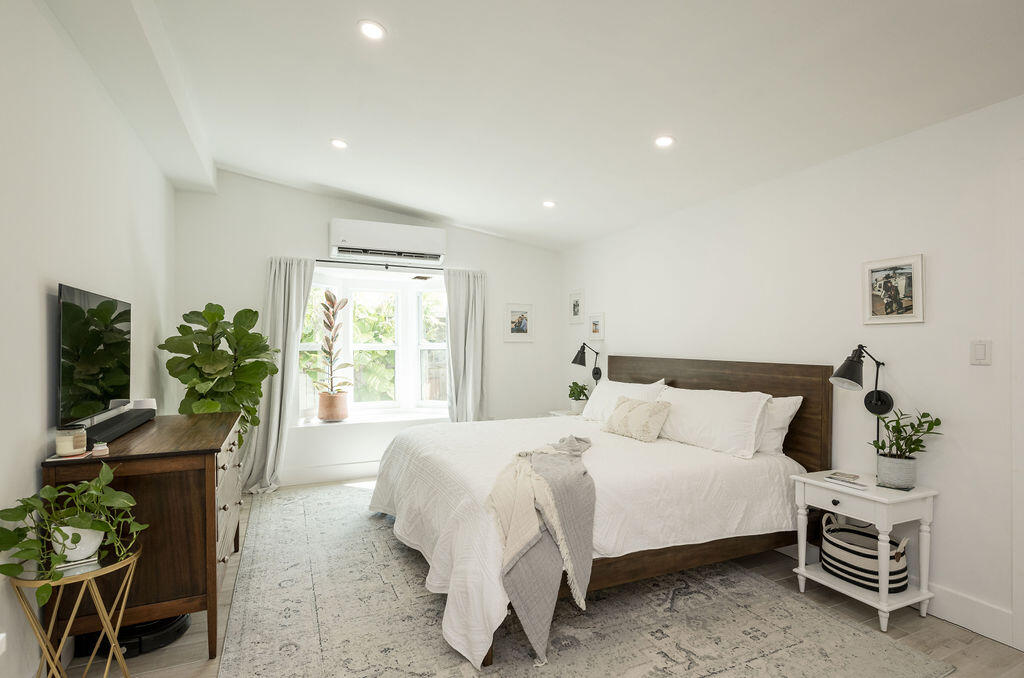 3402 Eagle Avenue Key West, FL 33040 - Photo 16 of 27 a bedroom with a bed table chair and a window