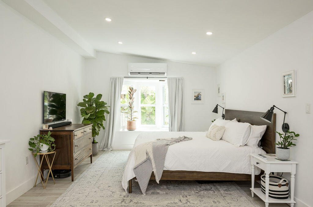 3402 Eagle Avenue Key West, FL 33040 - Photo 20 of 27 a bedroom with a bed and a flat tv screen on the dresser