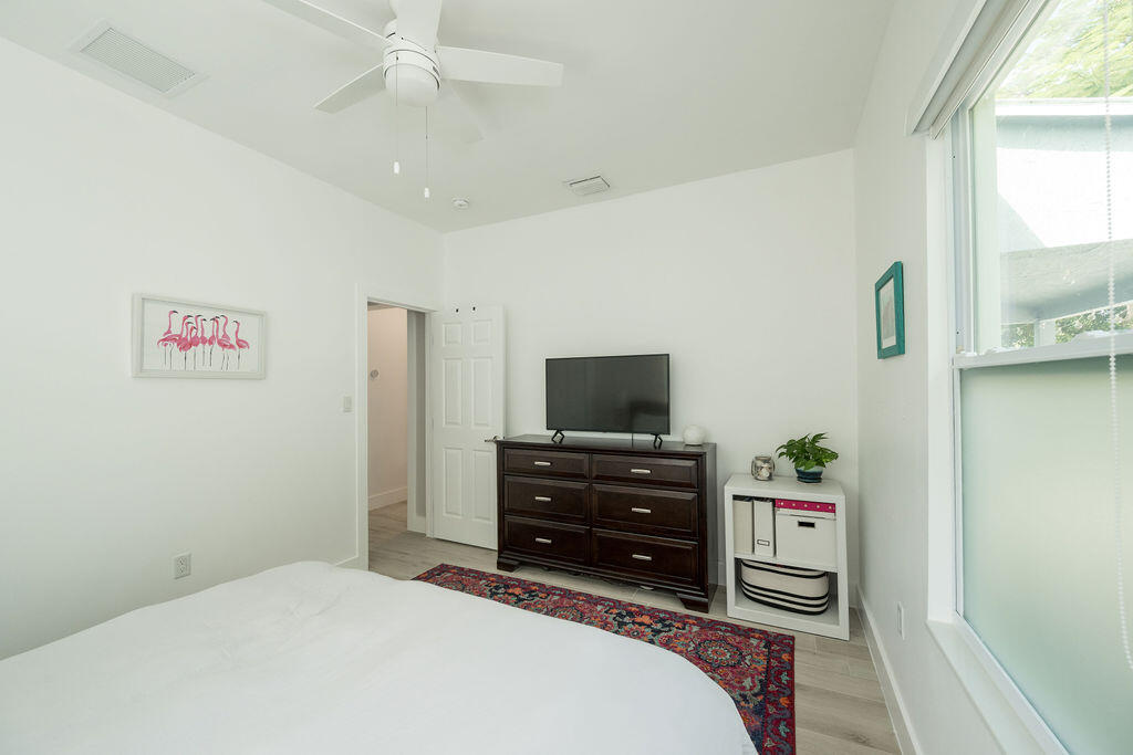 3402 Eagle Avenue Key West, FL 33040 - Photo 23 of 27 a bedroom with a bed and a flat tv screen on dresser