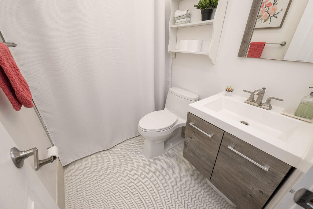 3402 Eagle Avenue Key West, FL 33040 - Photo 25 of 27 a bathroom with a sink toilet and a mirror