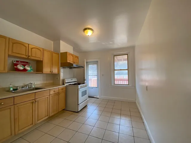 a kitchen with stainless steel appliances granite countertop a sink and cabinets
