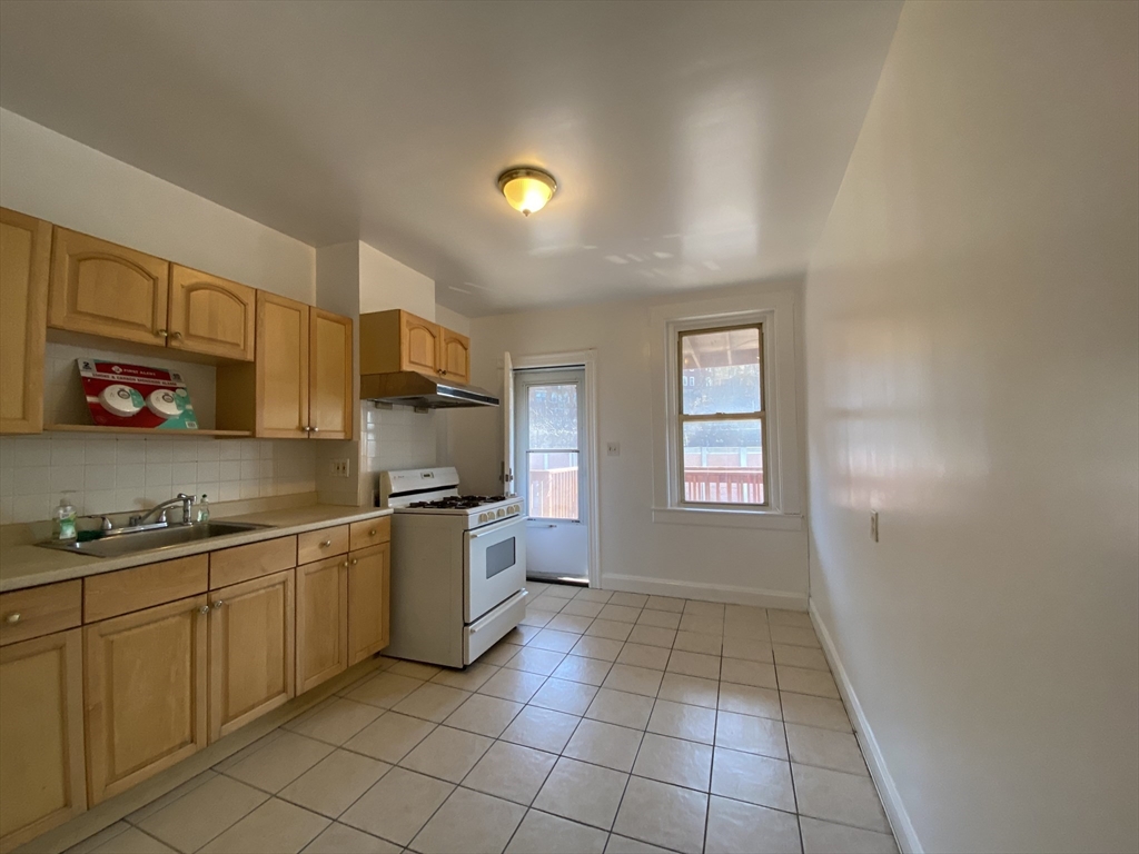 884 Huntington Avenue, Unit 3 Boston, MA 02115 - Photo 1 of 9 a kitchen with stainless steel appliances granite countertop a sink and cabinets