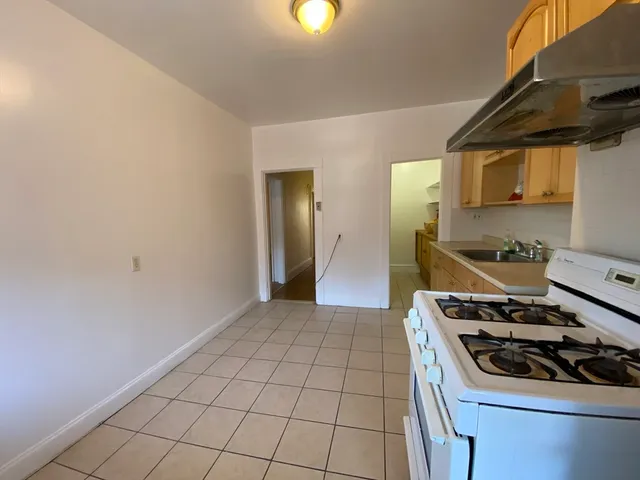 a kitchen with a stove and a refrigerator