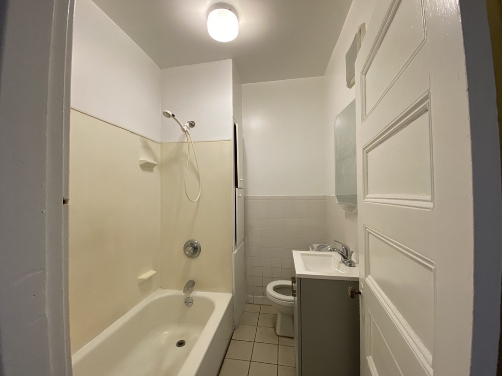 884 Huntington Avenue, Unit 3 Boston, MA 02115 - Photo 6 of 9 a bathroom with a sink a toilet and shower