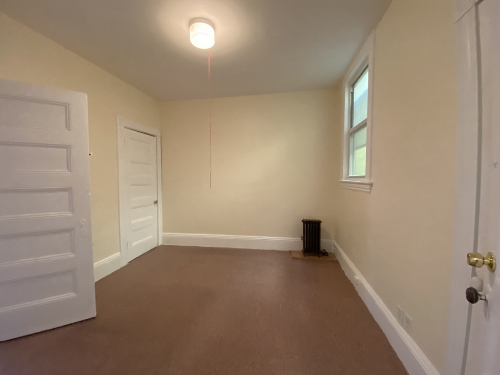 884 Huntington Avenue, Unit 3 Boston, MA 02115 - Photo 7 of 9 a view of an empty room with a window