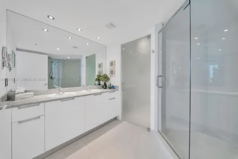 a bathroom with a double vanity sink and mirror