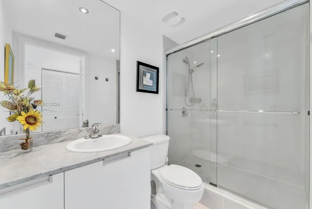 a bathroom with a sink toilet and shower