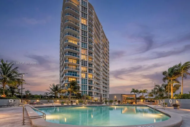 a view of swimming pool with outdoor seating and city view
