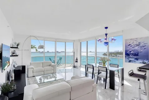 a living room with furniture a floor to ceiling window and a flat screen tv