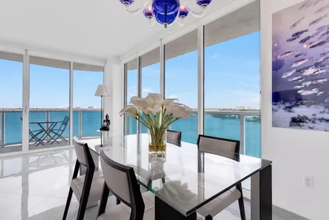 a view of a dining room with furniture and a potted plant