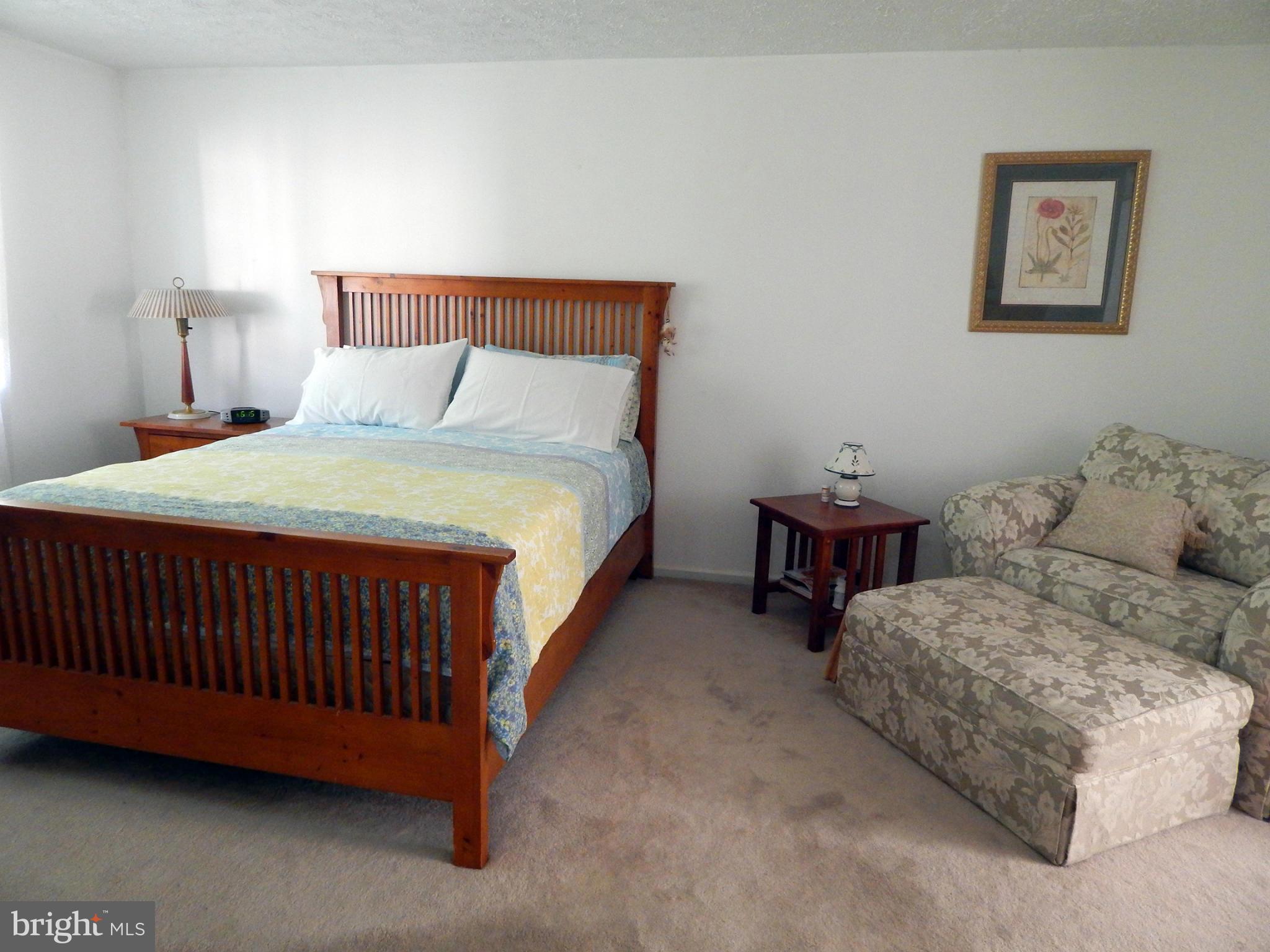 5776 Heming Avenue Springfield, VA 22151 - Photo 14 of 25 a bedroom with bed and a couch
