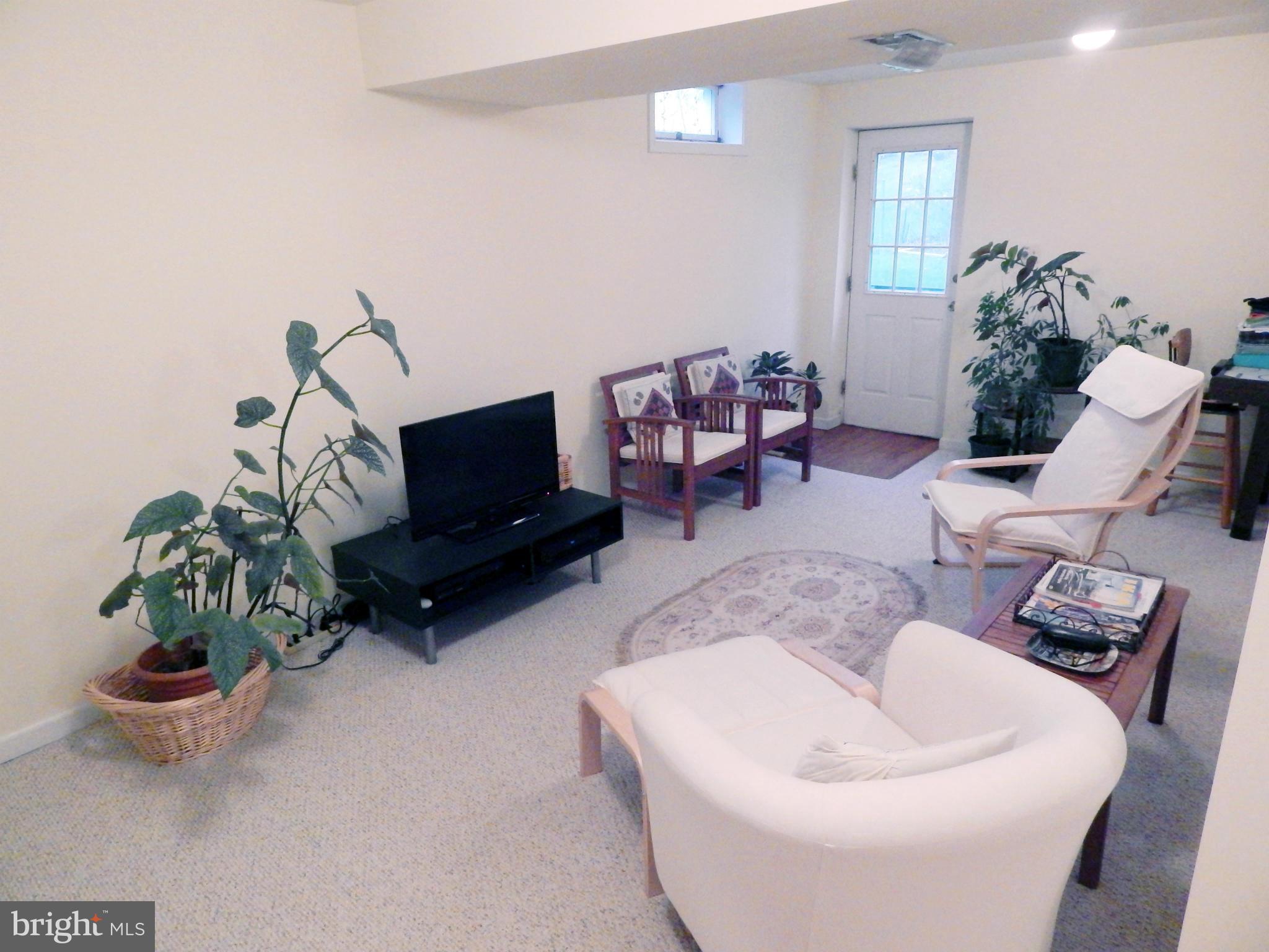 5776 Heming Avenue Springfield, VA 22151 - Photo 24 of 25 a living room with furniture and a flat screen tv