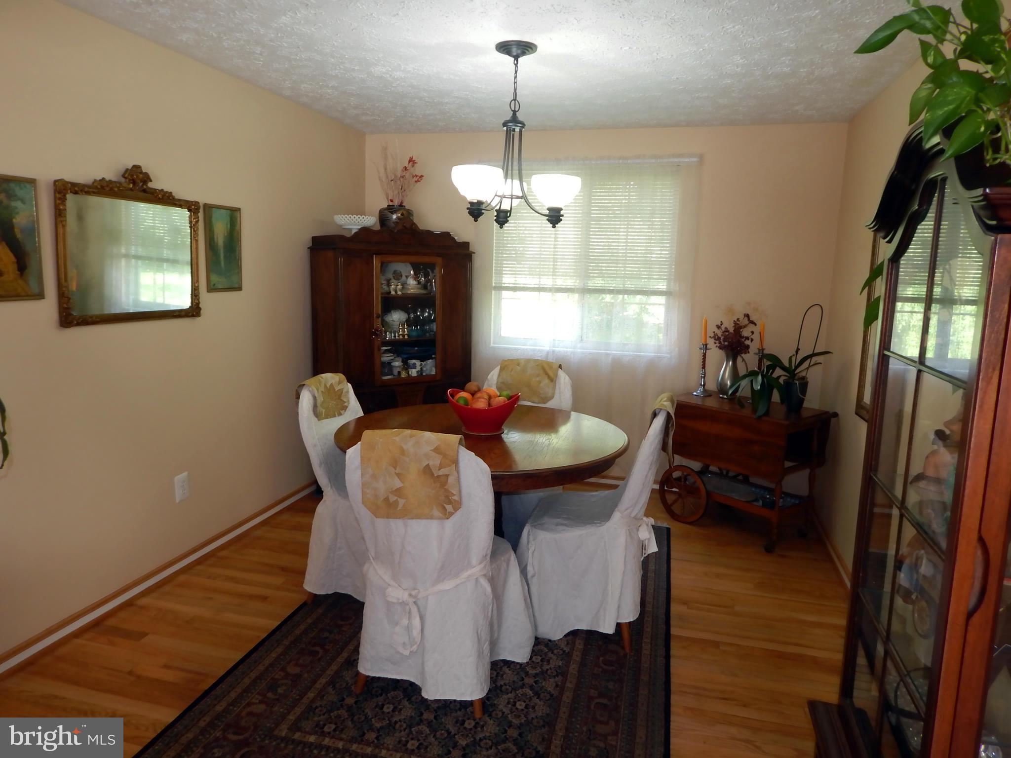 5776 Heming Avenue Springfield, VA 22151 - Photo 7 of 25 a dining room with furniture a chandelier and window