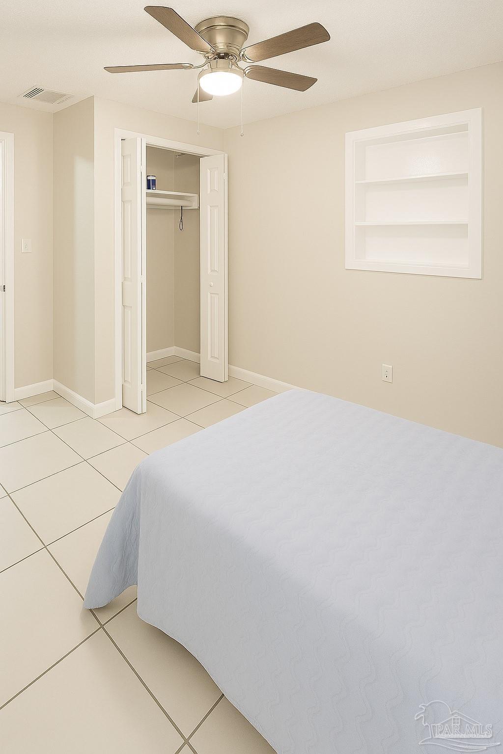6274 Munson Highway Milton, FL 32570 - Photo 18 of 26 a bed room with a bed and a ceiling fan