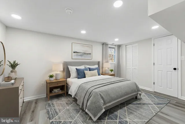 a bedroom with a bed and a potted plant